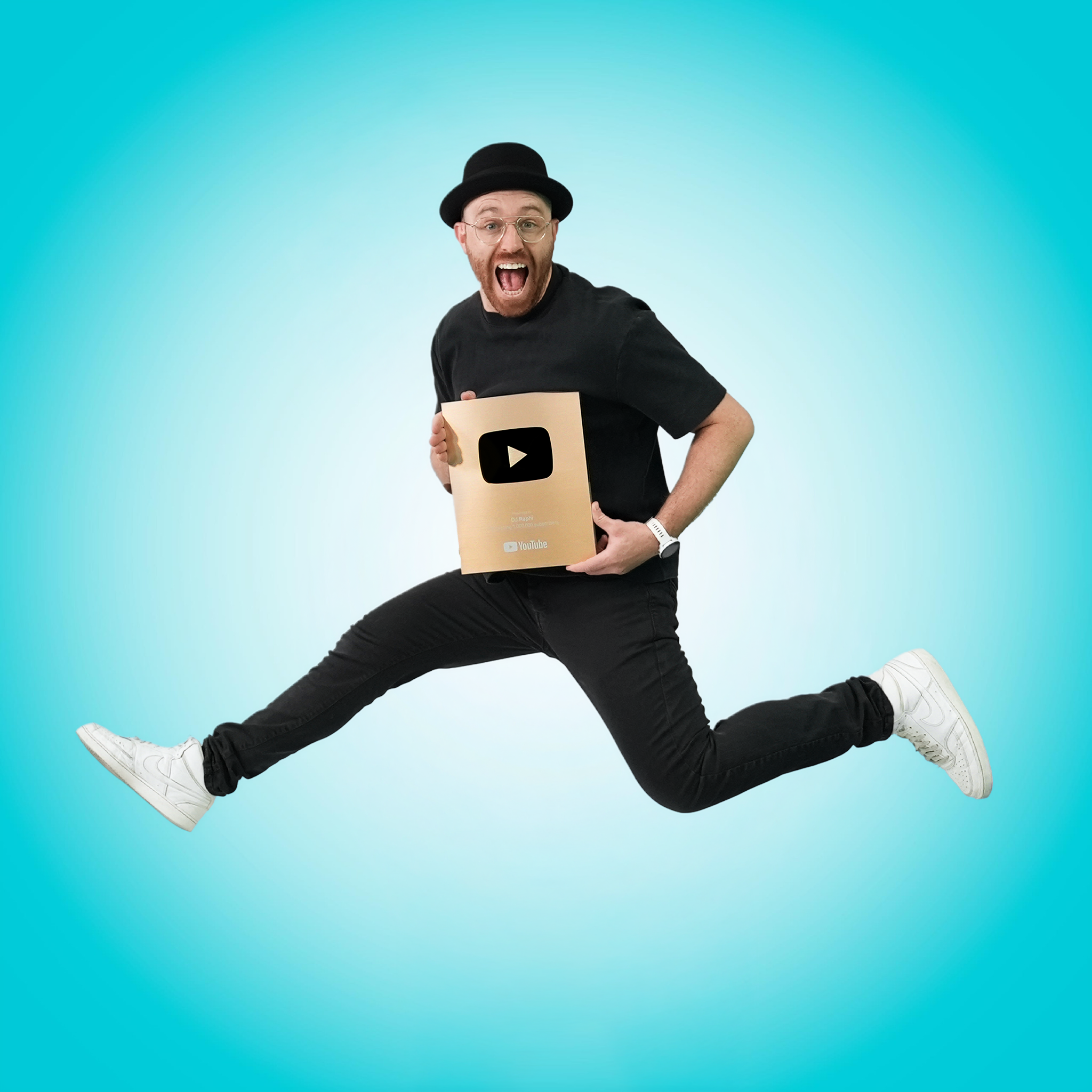 DJ Raphi smiling in a black hat and teal glasses